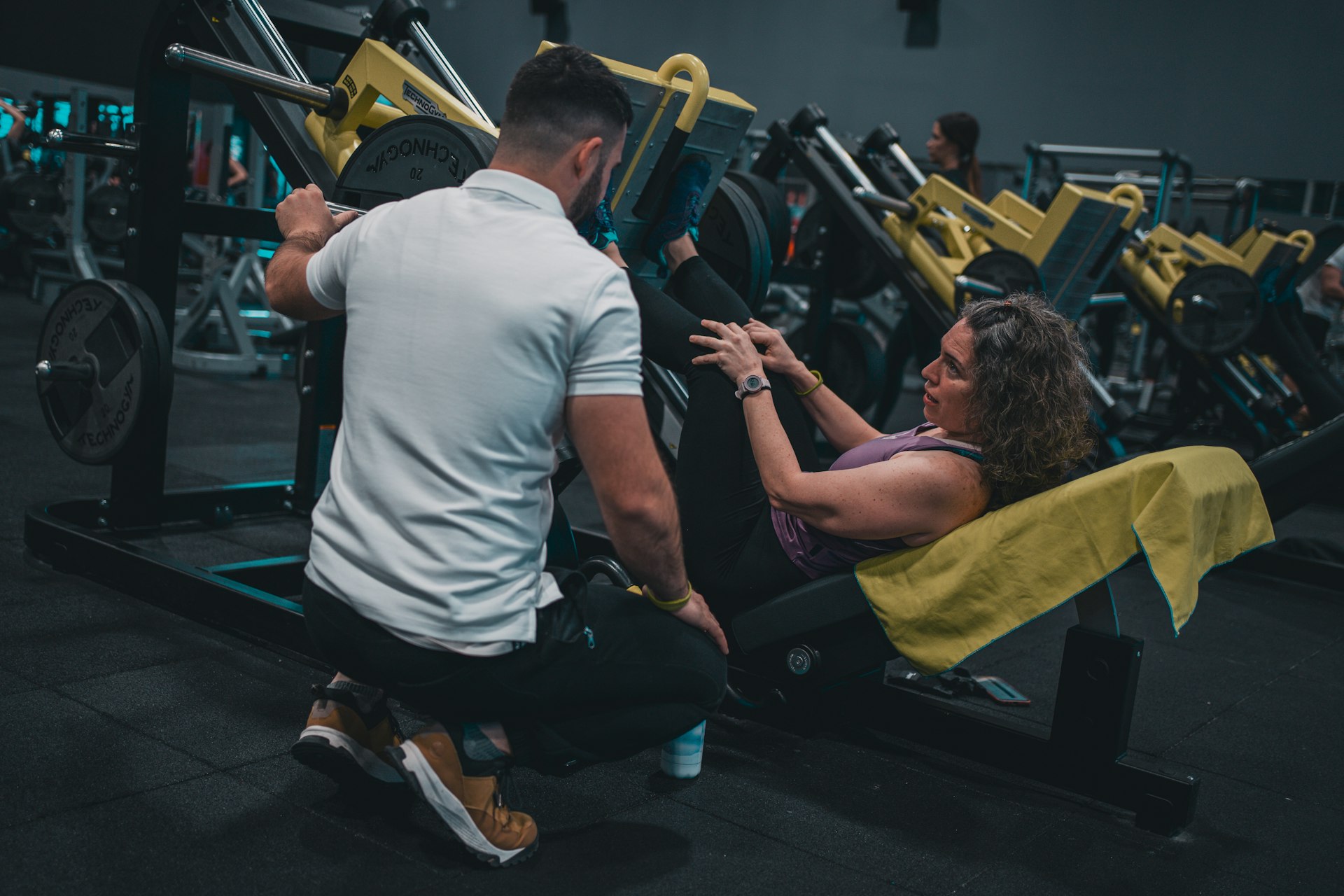 A man and a woman working out in a gym